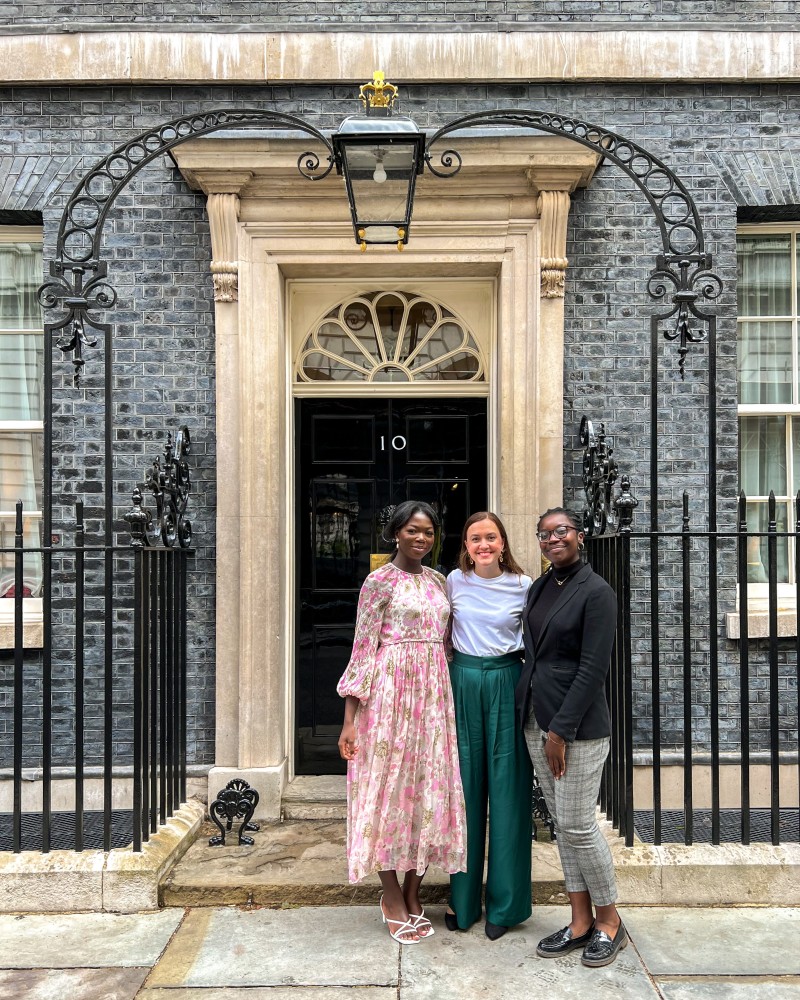 Three women standing in front of Number 10 Downing Street.